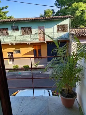 a view from the balcony of a house with a plant at Zacatecoluca House Hostel 2 nivel in Zacatecoluca