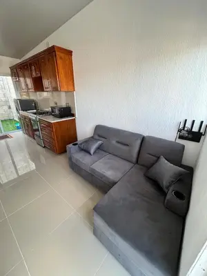 a living room with a couch and a kitchen at Casa de las villas 3 in San Miguel