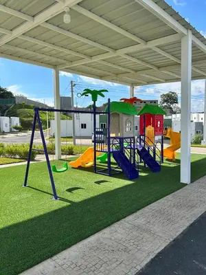 an outdoor playground with slides and swings at Casa de las villas 3 in San Miguel
