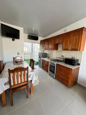 a kitchen with a table and a stove top oven at Casa de las villas 3 in San Miguel