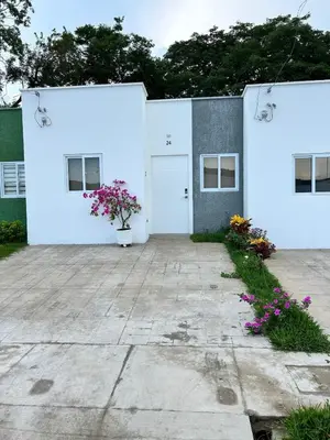 a white building with purple flowers in a courtyard at Casa de las villas 3 in San Miguel