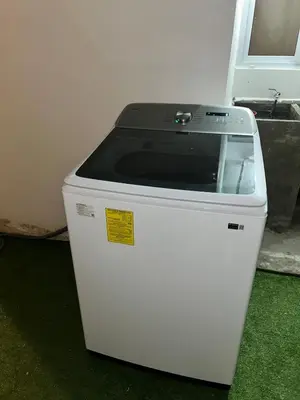 a white cooler sitting on the floor next to a wall at Casa de las villas 3 in San Miguel