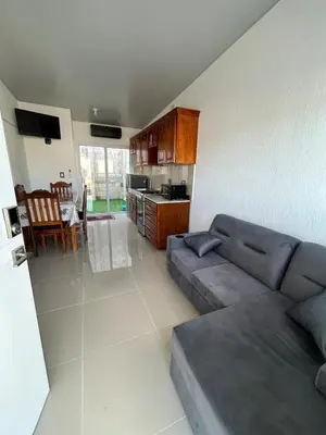 a living room with a couch and a kitchen at Casa de las villas 3 in San Miguel
