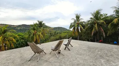 two wooden chairs sitting on top of a roof at 4 Amigos El Zonte in ChiltiupÃ¡n