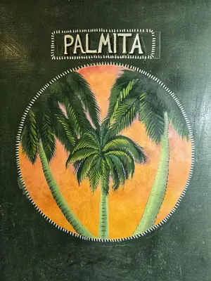 a label with a palm tree on it at 4 Amigos El Zonte in ChiltiupÃ¡n