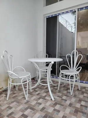 a white table and four chairs in a room at Veraneras House, your home in Santa Ana, El Salvador in Santa Ana