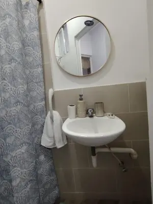 a bathroom with a sink and a mirror at Veraneras House, your home in Santa Ana, El Salvador in Santa Ana