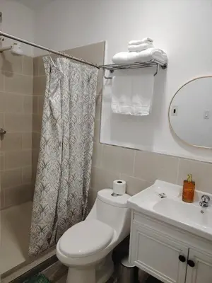 a bathroom with a toilet and a sink and a mirror at Veraneras House, your home in Santa Ana, El Salvador in Santa Ana
