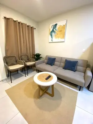 a living room with a couch and a table at Cozy house 5 minutes from the airport in Las Flores