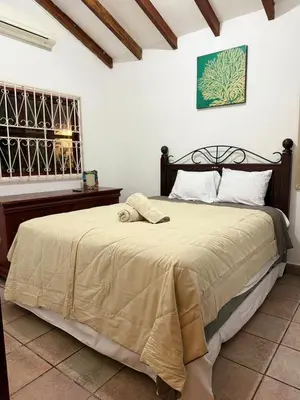a bedroom with a bed and a window and a piano at Casa Marea - Costa del Sol in Marcelino