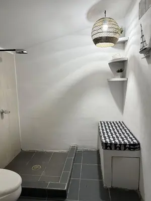 a bathroom with a toilet and a chandelier at Casa Marea - Costa del Sol in Marcelino