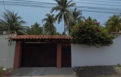 a building with a garage with a plant on it at Casa Marea - Costa del Sol in Marcelino