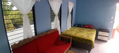 a small bedroom with a bed and a window at Hospedaje Mi Casita in Chalchuapa