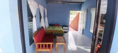 a room with two chairs and a table on a balcony at Hospedaje Mi Casita in Chalchuapa