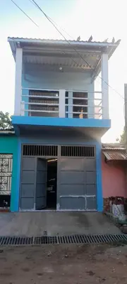 a house with two garage doors in front of it at Hospedaje Mi Casita in Chalchuapa