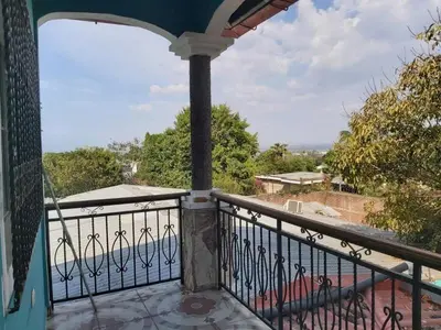 a balcony with a view of the ocean at Ahuachapán Getaway