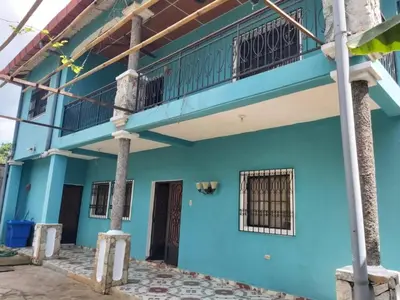 a blue building with a balcony on top at Ahuachapán Getaway