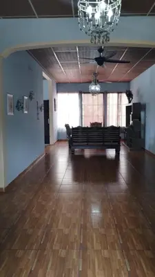 a large empty room with a bench and a chandelier at Ahuachapán Getaway