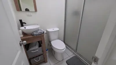a bathroom with a toilet and a sink and a shower at La Casa de Miranda in San Miguel