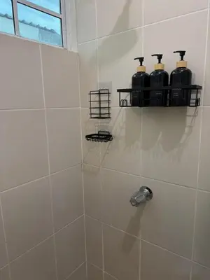 a bathroom with a shower with two bottles on a shelf at La Casa de Miranda in San Miguel