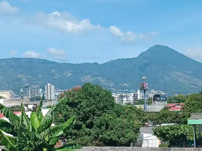 a view of a city with a mountain in the background at habitación doble cerca de todo in San Salvador