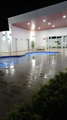 an empty parking lot with a pool in a building at Joseline House in San Miguel