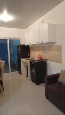 a kitchen with a stove and a couch in a room at Joseline House in San Miguel