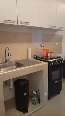 a kitchen with a sink and a stove at Joseline House in San Miguel