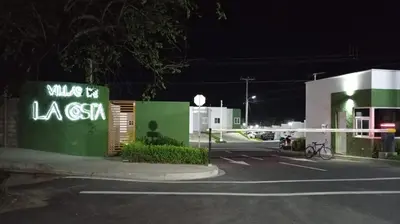a parking lot with a gas station at night at Joseline House in San Miguel
