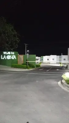 a parking lot with a sign that reads was the losc sign at Joseline House in San Miguel