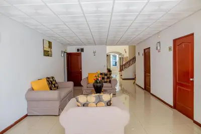 a living room with couches and chairs in a room at Hotel Windsor Plaza in San Salvador