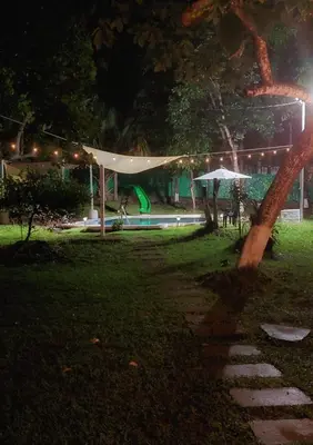 a park at night with a tent and a playground at Jardín Escondido in La Libertad