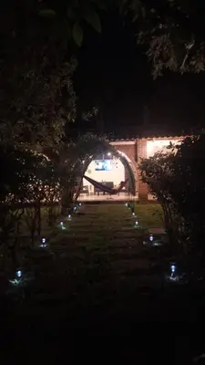 an archway with lights in a park at night at Jardín Escondido in La Libertad