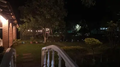 a white fence in a yard at night at Jardín Escondido in La Libertad