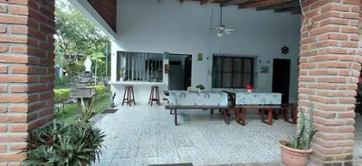a patio of a house with a table and chairs at Jardín Escondido in La Libertad