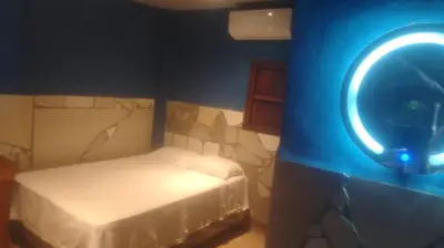a small room with a bed and a mirror at Kchimbon rooms best place stay view all Zonte in El Zonte