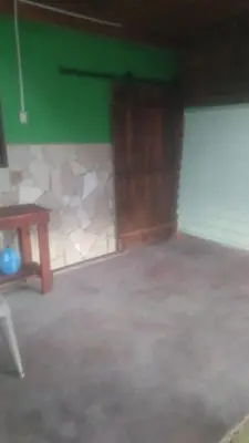 a room with a green wall and a table at Kchimbon rooms best place stay view all Zonte in El Zonte