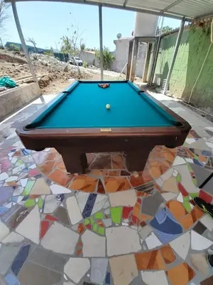a pool table on a patio with a mosaic floor at Kchimbon rooms best place stay view all Zonte in El Zonte