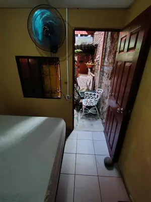 a view of a room with a door and a chair at Rooms libertad in San Salvador