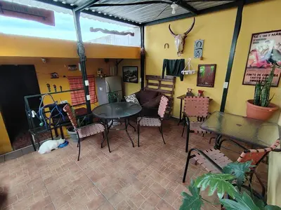 a room with a table and chairs in a room at Rooms libertad in San Salvador