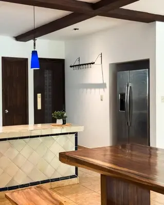 a kitchen with a stainless steel refrigerator and a counter at Casa Cielo in La Libertad