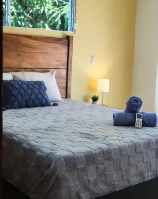 a bed with two blue towels on top of it at Casa Cielo in La Libertad