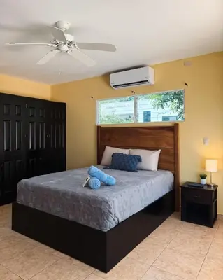 a bedroom with a bed with a ceiling fan at Casa Cielo in La Libertad