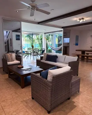 a living room with couches and a table and chairs at Casa Cielo in La Libertad