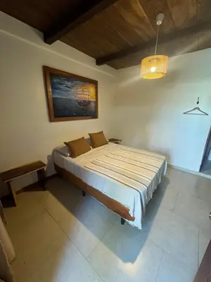 a bedroom with a large bed in a room at Dos Palmas in El Sunzal