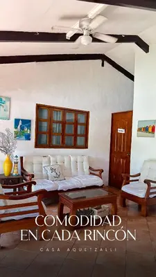 a living room with a couch and a ceiling fan at Casa Aquetzalli in San Salvador