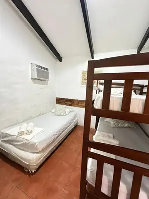 a room with two bunk beds and a fan at Casa Aquetzalli in San Salvador