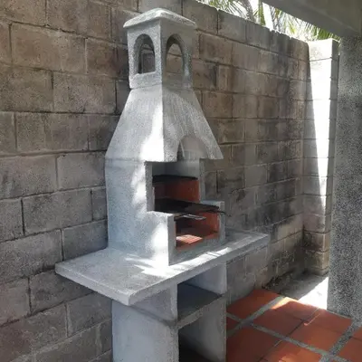 a brick wall with a pizza oven on a table at Casa Aquetzalli in San Salvador
