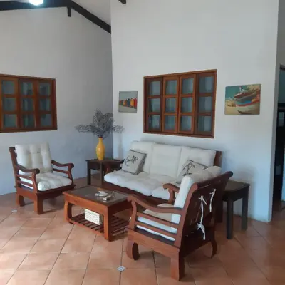 a living room with a couch and chairs and a table at Casa Aquetzalli in San Salvador