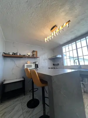 a kitchen with a counter and a counter top in a room at Villa Napoli Apartment Suites in Santa Ana